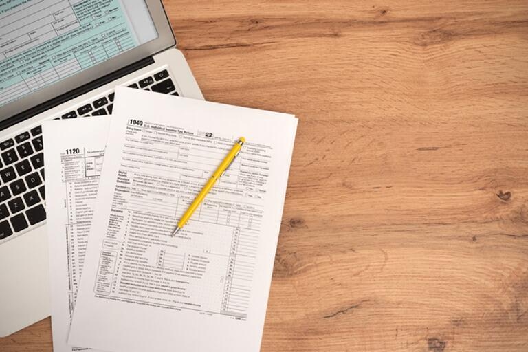 W-2 forms laying on top of a laptop.