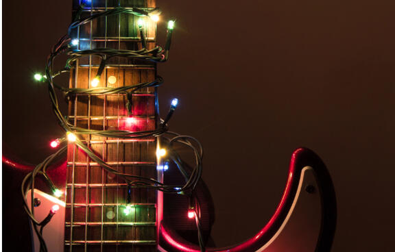 electric guitar wrapped in colored lights