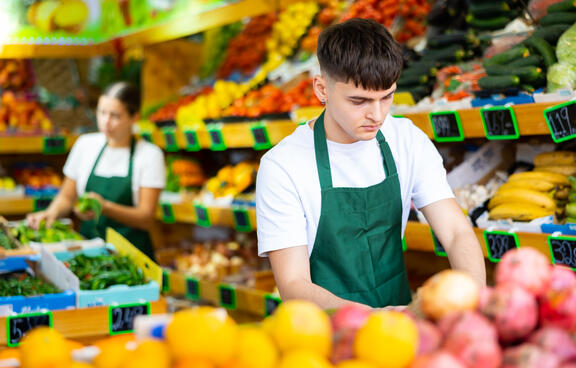 teen boy working at grocery store.