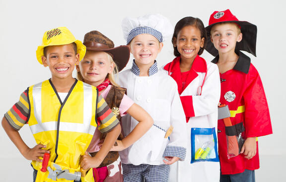 children dressed up as future careers. One fireman, one cowboy, a chef, construction worker, and doctor.